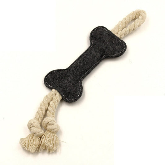 Dog toy with a bone-shaped felt piece and rope handles on a white background