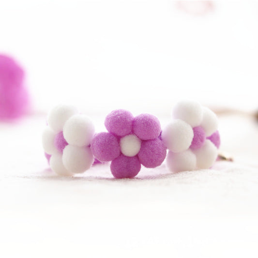 Pair of pink and white flower-shaped collar on a light background